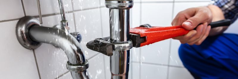 Plumber performing leak repair